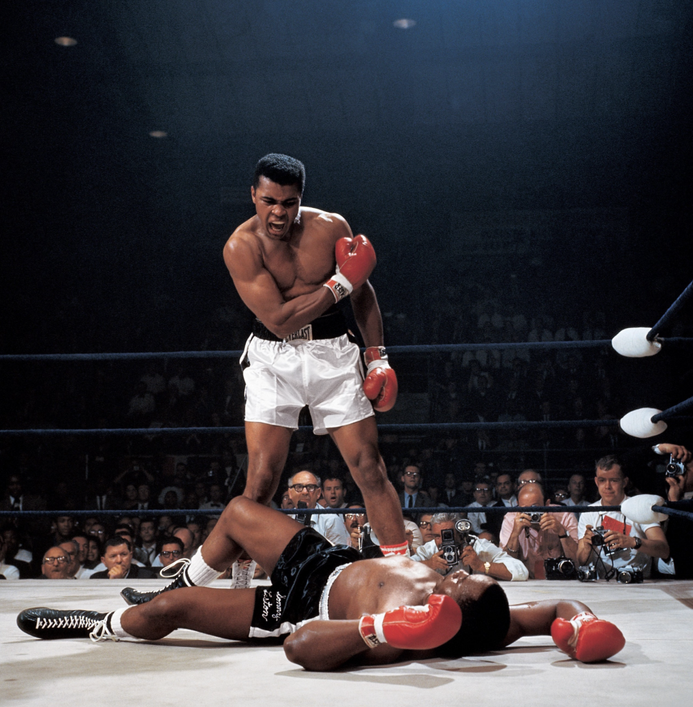 Muhammad Ali stands over opponent in fight